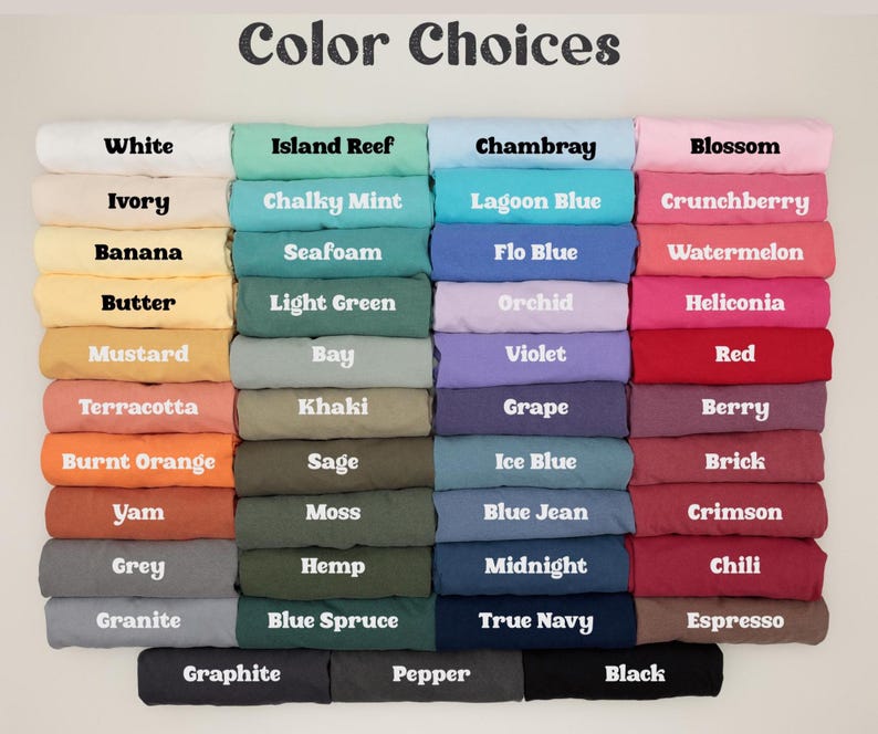May include: A color chart displaying folded t-shirts in various shades. The text labels include White, Ivory, Banana, Butter, Mustard, Terracotta, Burnt Orange, Yam, Grey, Granite, Graphite, Island Reef, Chalky Mint, Seafoam, Light Green, Bay, Khaki, Sage, Moss, Hemp, Blue Spruce, Pepper, Chambray, Lagoon Blue, Flo Blue, Orchid, Violet, Grape, Ice Blue, Blue Jean, Midnight, True Navy, Blossom, Crunchberry, Watermelon, Heliconia, Red, Berry, Brick, Crimson, Chili, Espresso, and Black.