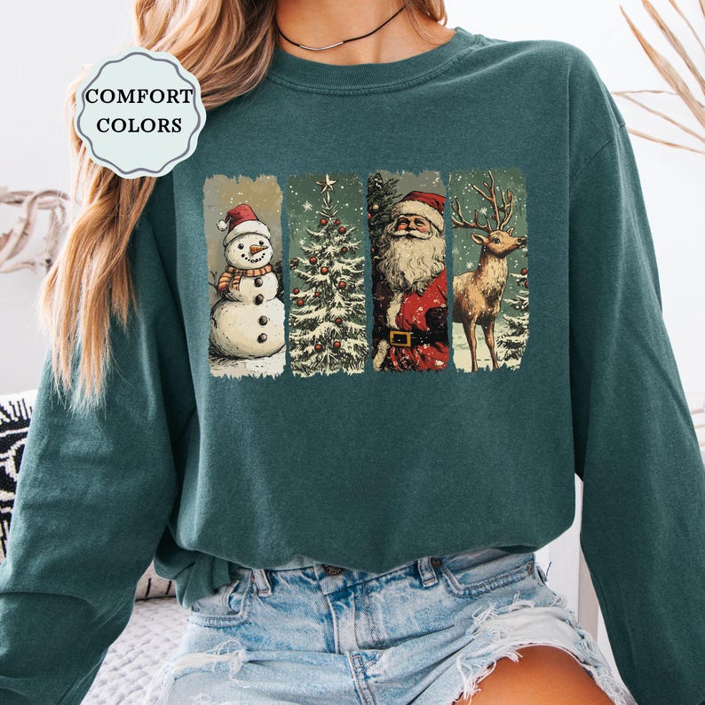May include: Teal Comfort Colors sweatshirt featuring a festive Christmas design. The graphic includes a snowman, Christmas tree, Santa Claus, and a reindeer. The design is in a vintage style, perfect for the holiday season.