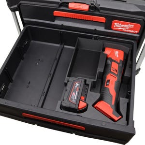 May include: Black and red Milwaukee Packout tool box drawer with a red and black multi-tool and a 5.0 Ah battery. The drawer is open, revealing compartments for tools and accessories. The Milwaukee Packout logo is visible.