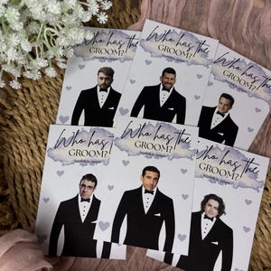 May include: A collection of rectangular game cards featuring the text Who has the GROOM? Scratch to reveal. Each card displays a different man in a black tuxedo with a bow tie, surrounded by small light purple hearts on a white background.