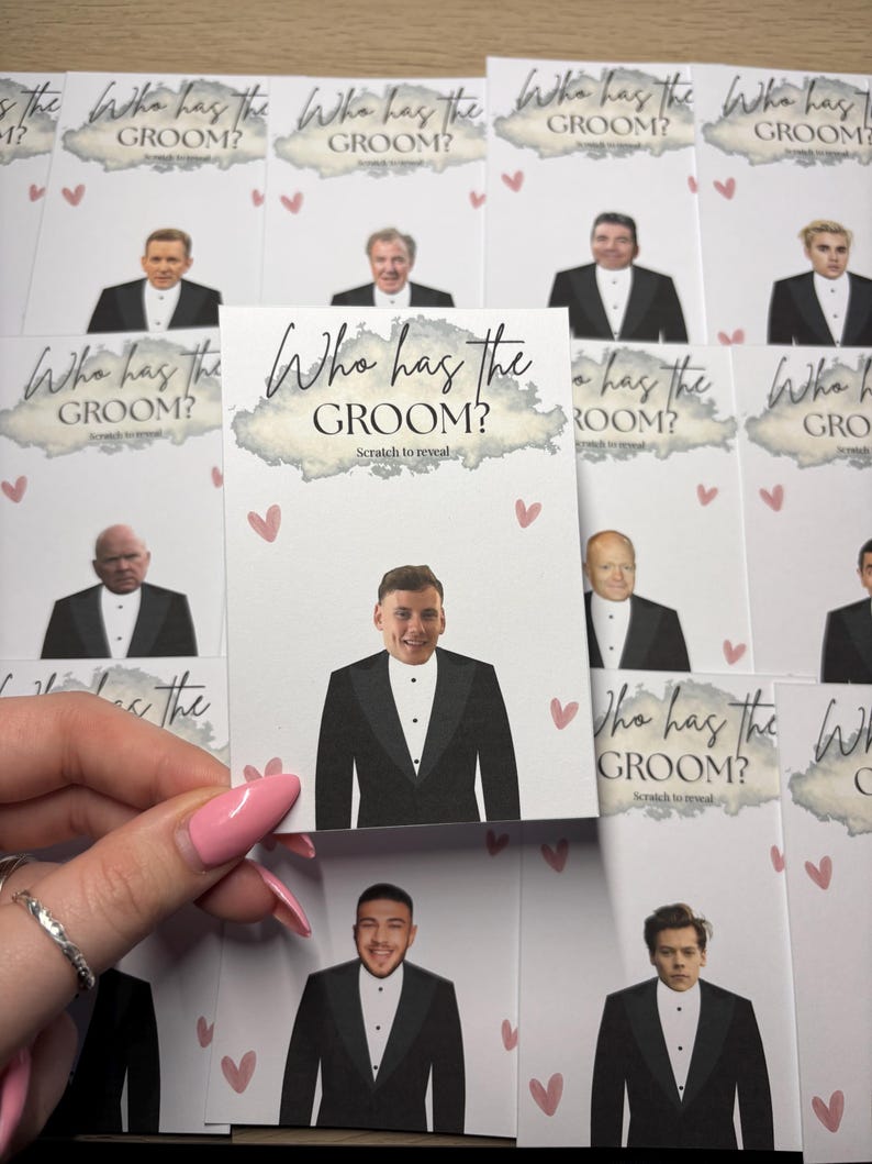 May include: A collection of rectangular game cards titled Who has the GROOM? with the instruction Scratch to reveal. Each white card features a printed illustration of a person in a black tuxedo and small pink hearts scattered across the surface.
