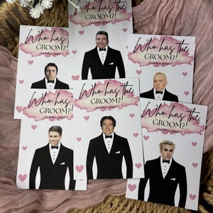 May include: A collection of rectangular scratch-off game cards featuring the text Who has the GROOM? Scratch to reveal. Each card displays a different male celebrity wearing a black tuxedo and bow tie, accented by pink watercolour and heart graphics.