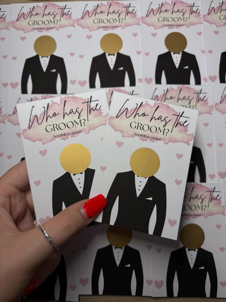 May include: A collection of rectangular game cards featuring the text Who has the GROOM? Scratch to reveal. Each card displays a black tuxedo illustration with a circular gold scratch-off sticker where the head would be, accented by pink hearts.