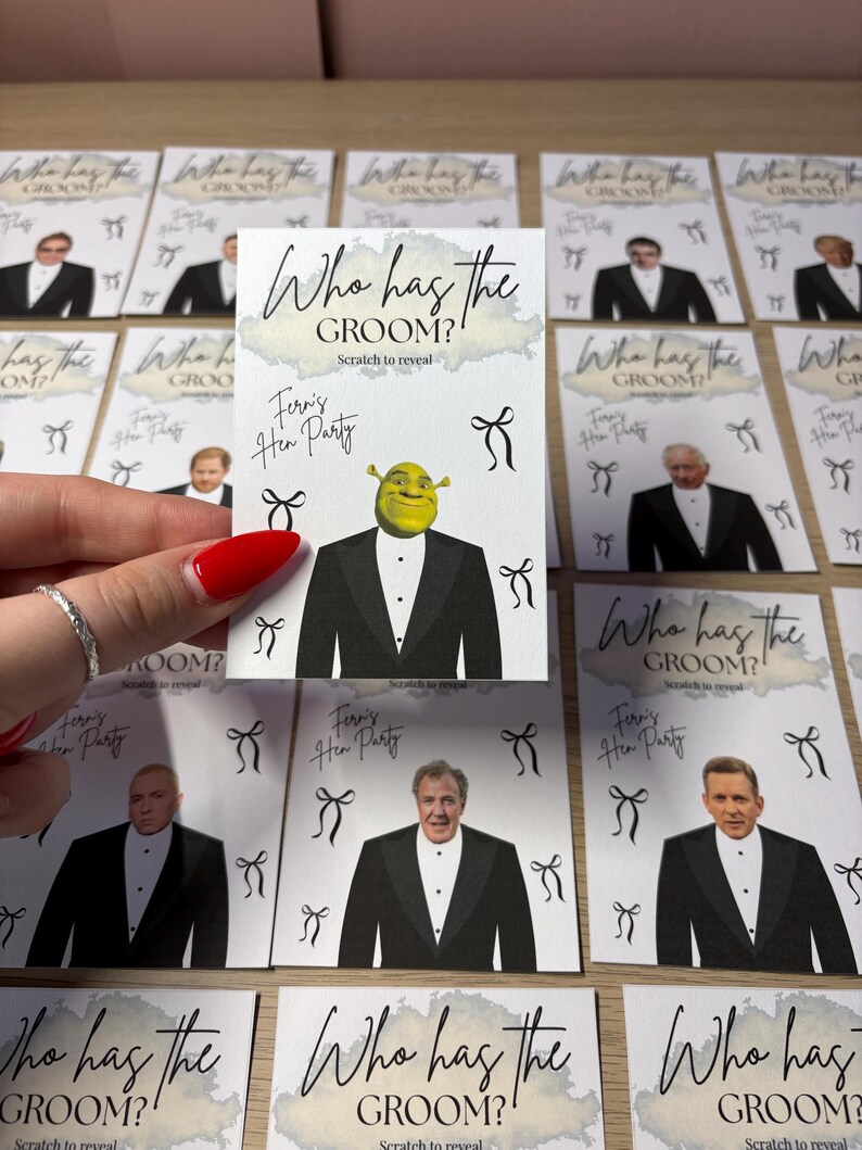 May include: A rectangular game card featuring the text Who has the GROOM? and Scratch to reveal. The card displays a graphic of Shrek in a tuxedo, the handwritten text Fern's Hen Party, and several black bow illustrations on a white background.
