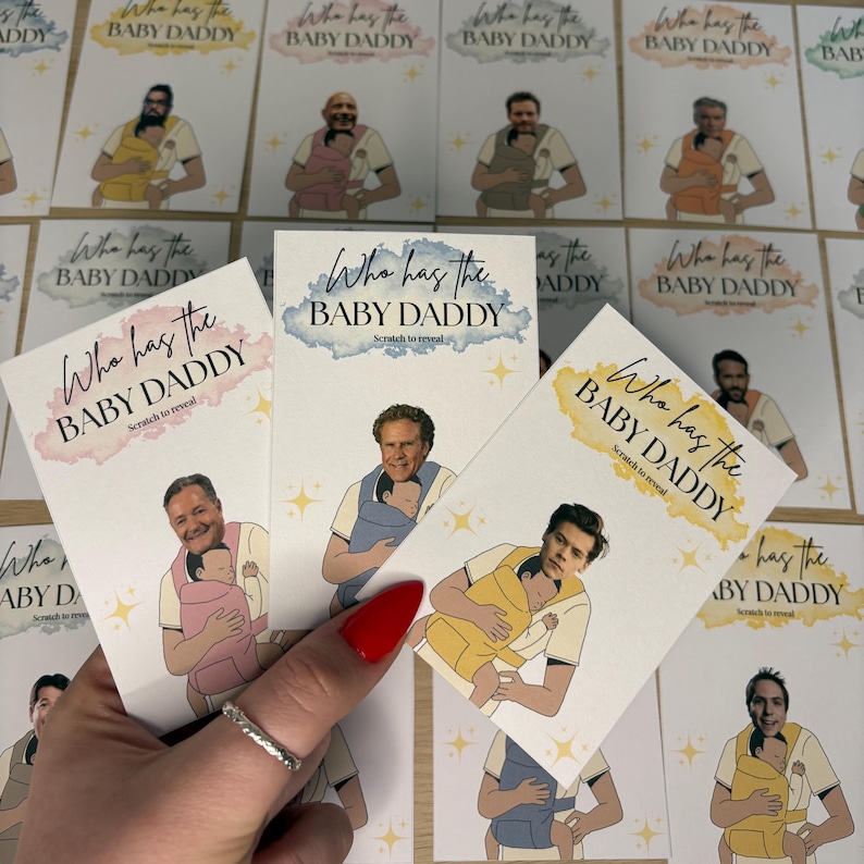 May include: Cards with the text "Who has the BABY DADDY" and "Scratch to reveal". The cards feature illustrations of men holding babies in carriers. The cards have a watercolor effect in pink, blue, and yellow.