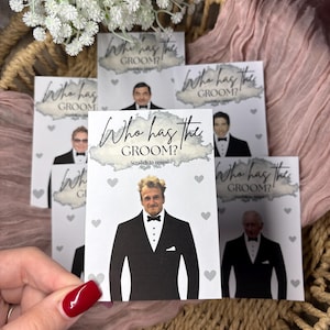 May include: A collection of rectangular game cards titled Who has the GROOM? with the text Scratch to reveal. Each card features a printed image of a man in a black tuxedo and bowtie, surrounded by small grey heart icons on a white background.