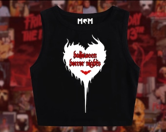 May include: Black crop top with a white heart-shaped graphic that reads "Halloween Horror Nights" in red gothic lettering. A small red bat is below the text. The top has the letters "M&M" at the neckline.