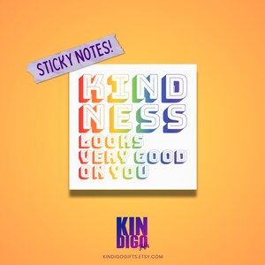 May include: Rainbow colored sticky note with the text "KINDNESS LOOKS VERY GOOD ON YOU". The sticky note is on a light orange background.