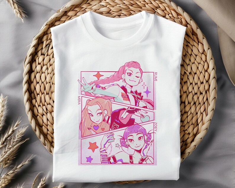 May include: White t-shirt featuring a colorful anime-style graphic. The graphic depicts three female characters in a comic book panel design, with names "Miha", "Rumi", and "Zoey". The artwork uses pink, purple, and red hues.