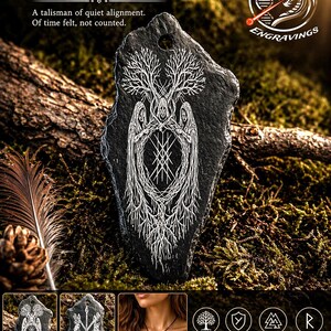 May include: A black slate stone pendant featuring a white hand-engraved design of three hooded figures intertwined with tree branches and a central geometric symbol. The piece includes a hole at the top for suspension and displays Norse imagery.