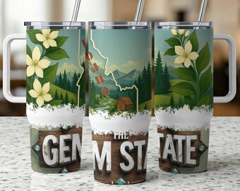May include: Three stainless steel travel mugs with white handles and lids. Each mug features a design with the state of Idaho, a cabin, and the text "THE GEM STATE". The mugs also have a floral design and a silver straw.