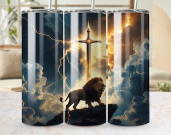 May include: A stainless steel tumbler featuring a dramatic design of a lion, a cross-shaped sword, and a stormy sky with lightning. The artwork is rendered in shades of brown, gold, and blue, creating a striking visual effect. The tumbler has a straw.