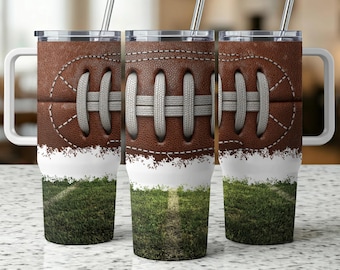 May include: Three stainless steel tumblers with a football design. The top half of each tumbler features a brown football pattern with white stitching. The bottom half has a white band and a green grass field design. Each tumbler has a silver straw.