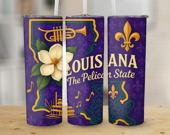 May include: A purple tumbler featuring a gold trumpet, a white magnolia flower, and the text "LOUISIANA The Pelican State." The design includes musical notes, a fleur-de-lis, and a steamboat illustration. The tumbler has a silver lid.