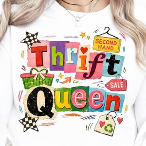 May include: White sweatshirt with a colorful graphic that reads "Thrift Queen." The design includes a shopping basket, stars, hearts, and a "Second Hand" sign. The letters are in various colors and styles.