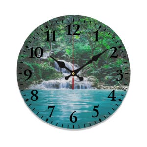 May include: Round wall clock featuring a serene waterfall scene with turquoise water and lush green foliage. The clock face has black numerals and hands, with a red second hand. The clock is a decorative item for home decor.