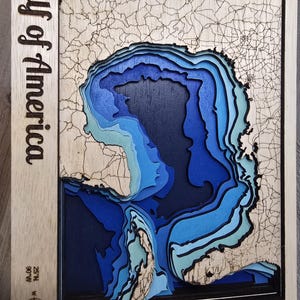 Gulf of America topographic wood layered map.