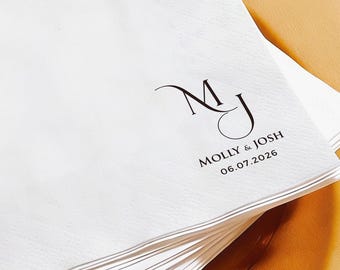 May include: A stack of white square napkins with the initials "MJ" and the names "Molly & Josh" along with the date "06.07.2026" printed in black. The napkins are on a clear amber-colored plate.