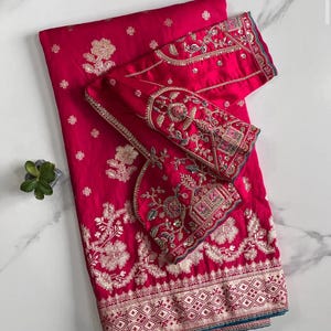 Pure Banarasi pattu saree with weaving motifs. weaving border on either side. Rich and elegant weaving pallu. Ideal for festive wear.