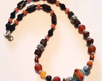 Beaded Necklace with a lampwork handmade  Bead in orange and turquoise , silver accents and coordinating beads.