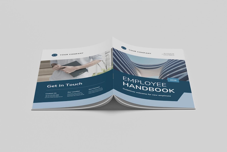 May include: An open employee handbook with a blue and white design. The cover reads "Employee Handbook" with the year 2018. The left page says "Get in Touch". The handbook is on a light grey surface.