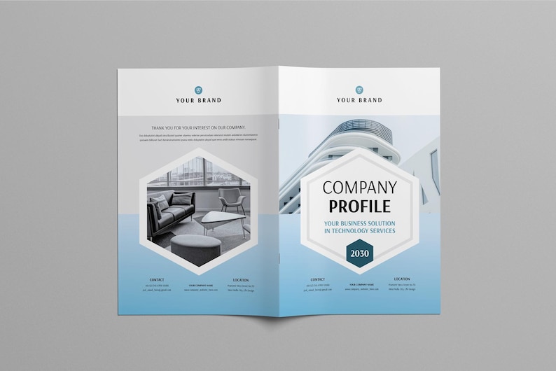 May include: An open brochure with a blue and white design. The text "YOUR BRAND" is at the top. The brochure displays a company profile with text and images, including a modern building and a living room scene.