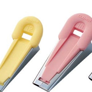 May include: Set of five Clover brand seam rippers with different colored plastic handles. The handles are shaped like a loop with a number printed on them. The numbers are 1/8, 1/4, 1/2, 3/8, and 2/8.
