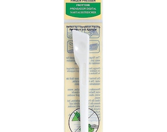 May include: White plastic finger presser tool for quilting and applique. The tool is labeled "Finger Presser" and "Frottoir" in black text. The packaging also includes the text "Art No. 495" and "Clover" in green text.
