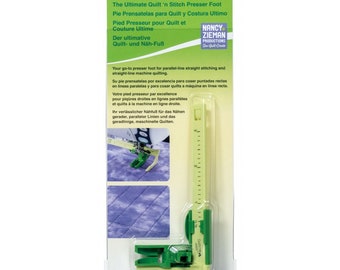 May include: Green and yellow Clover brand quilt 'n stitch presser foot for sewing machines. The foot has a ruler on the side and is designed for parallel-line straight stitching and straight-line machine quilting. The packaging includes the text "The Ultimate Quilt 'n Stitch Presser Foot" and "Nancy Zieman Productions".