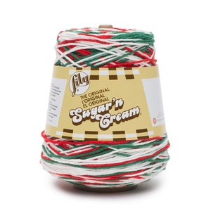 May include: A spool of Lily Sugar'n Cream yarn in a red, white, and green color combination. The yarn is labeled "The Original Sugar'n Cream" and is ready for crafting.