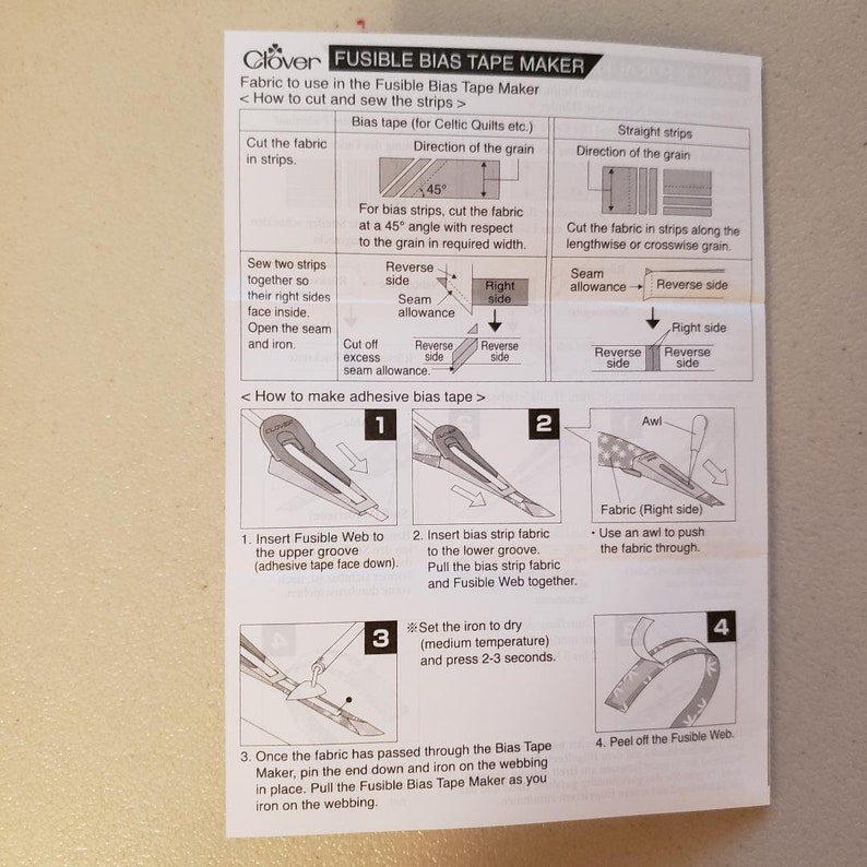 May include: Instructions for using a Clover Fusible Bias Tape Maker. The instructions show how to cut fabric strips, sew them together, and then use the tool to create bias tape. The steps are illustrated with diagrams and text.