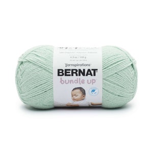 May include: A skein of Bernat Bundle Up yarn in a light green color. The label reads "Yarnspirations Bernat Bundle Up" and "100% Polyester/140g/267 yds/244m".