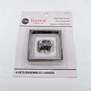 May include: Package of four sets of right angle corners for crafts. Each set includes four corner pieces and nails. The package is white with the Dritz home logo and the text "Right Angle Corners, Coins à angle droit, Esquinas en Ángulo Recto".