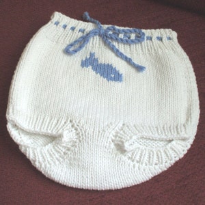 Hand knit white cotton pants or diaper cover with an embroidered whale and a drawstring at the waist