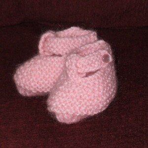 Hand knit pink booties for a newborn baby girl in a super soft blend of Lambs wool and Kid Mohair