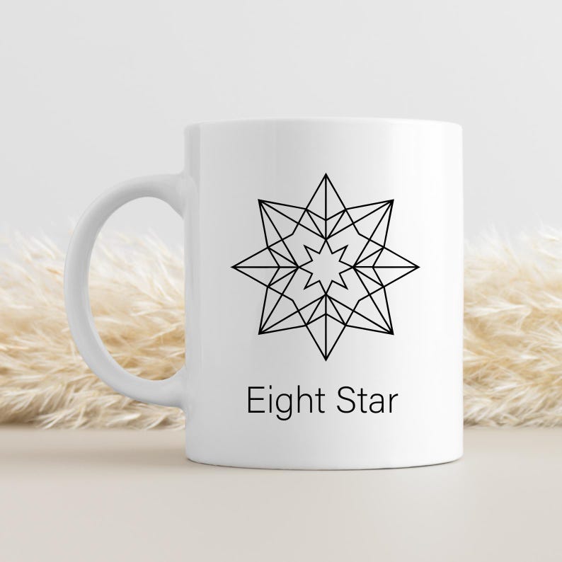 May include: White ceramic mug featuring a black geometric eight-pointed star design. The words "Eight Star" are printed below the star. The mug has a curved handle and is suitable for hot or cold beverages.