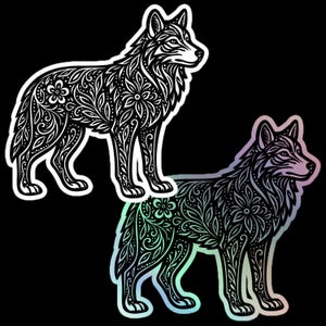 May include: Two wolf illustrations with detailed floral and leaf patterns. One is black and white, the other has a holographic, iridescent finish. Both are set against a black background, highlighting the intricate design of the animals.