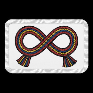May include: Embroidered patch featuring an infinity symbol design. The symbol is crafted from interwoven strands of red, blue, and yellow threads, with a black outline. The patch has a white background with a gray border.