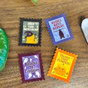 May include: Four colorful sticker designs with postage stamp edges. The stickers feature phrases like "Hex the Patriarchy," "Resist. Rest. Repeat," "Haunted by Capitalism," and "Smash This Pumpkin." Each design includes illustrations.