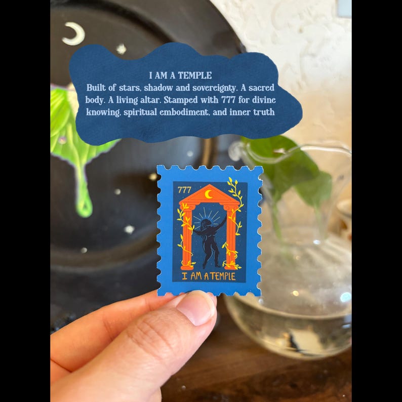 May include: A blue stamp with the text "I AM A TEMPLE" and the number "777". The stamp features an illustration of a figure inside an archway with orange and yellow accents. A handwritten note with text is in the background.