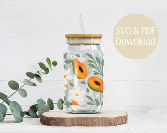 May include: A clear glass tumbler with a bamboo lid and a straw. The tumbler has a floral and papaya design with white flowers, green leaves, and orange papaya slices.