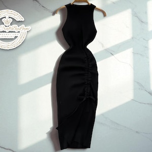 Può includere: Abito nero senza maniche con dettaglio arricciato laterale e spacco. L'abito è appeso a una gruccia di legno su uno sfondo di marmo bianco. L'abito è lungo fino al ginocchio.