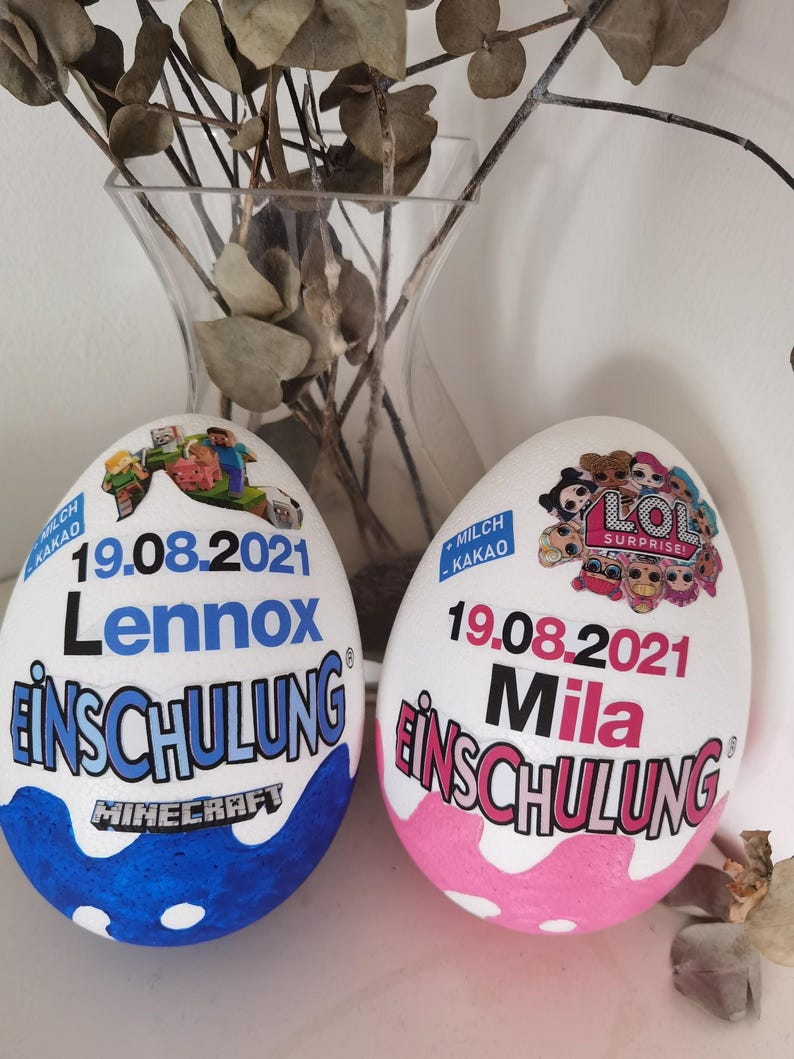 Pode incluir: Dois ovos brancos decorados com o texto "19.08.2021" e os nomes "Lennox" e "Mila" neles. Os ovos s&atilde;o decorados com um tema Minecraft e um tema LOL Surprise. O texto "Einschulung" est&aacute; em ambos os ovos.