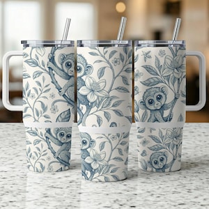 May include: Three stainless steel tumblers with a white background and blue floral pattern. Each tumbler features a different blue monkey illustration.