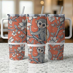 May include: Three stainless steel tumblers with lids and straws. Each tumbler features a different monkey design with a floral pattern on a coral background.