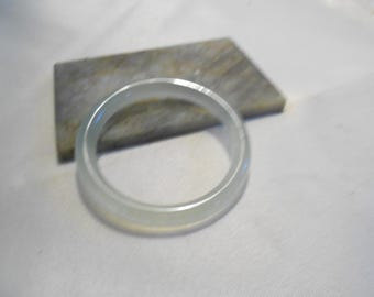 May include: A white jade bangle bracelet. The bangle is smooth and polished.