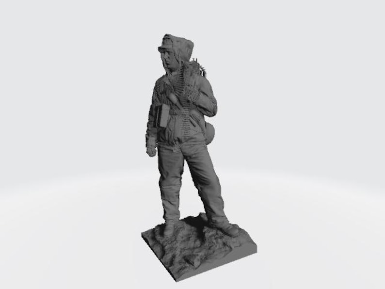 May include: A gray plastic figurine of a soldier wearing a hooded jacket and carrying a rifle and ammunition belt. The figurine is standing on a gray base.