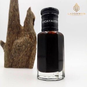 May include: A small, clear glass bottle with a black cap and a black label that reads "KHOAYAI250Y". The bottle is filled with a dark liquid.