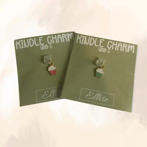 May include: Two green cards with the text "Kindle Charm USB C" and the text "Ellise Gifts & Design". Each card features a small cupcake charm with a gold hook.