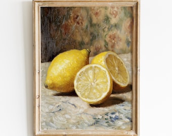 May include: A framed still life painting featuring three lemons. One whole lemon and two halves are arranged on a textured surface. The background has a floral pattern in muted tones, and the frame is a light wood color.